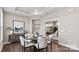 Dining room with stylish table setting, hardwood floors, and an adjacent study area at 8105 Stillhouse Ln # 23, Harrisburg, NC 28075