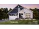 Charming two-story home with a two-car garage, covered entrance, manicured lawn and beautiful landscaping at 8105 Stillhouse Ln # 23, Harrisburg, NC 28075
