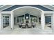 Cozy outdoor fireplace with comfortable seating is perfect for relaxing and socializing in this covered space at 8105 Stillhouse Ln # 23, Harrisburg, NC 28075