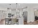 Bright kitchen featuring stainless steel appliances, pendant lighting, tile backsplash, and a center island with seating at 8105 Stillhouse Ln # 23, Harrisburg, NC 28075
