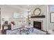 Inviting living room features fireplace with decor, neutral color palette, art, and a plush seating arrangement at 8105 Stillhouse Ln # 23, Harrisburg, NC 28075