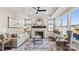 Inviting living room with a fireplace, large windows, neutral color palette, and comfortable seating arrangement at 8105 Stillhouse Ln # 23, Harrisburg, NC 28075
