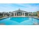 Enjoy a refreshing dip in this beautiful pool with ample seating and a covered area to relax at 8105 Stillhouse Ln # 23, Harrisburg, NC 28075