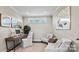 Cozy study room with a desk, comfortable seating, decorative mirrors, and a plant for a tranquil workspace at 8105 Stillhouse Ln # 23, Harrisburg, NC 28075