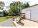 Backyard featuring a shed, patio with chairs, play equipment, and a trampoline at 8210 Lantana Dr, Denver, NC 28037