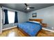 Comfortable bedroom featuring hardwood floors, a wooden bed frame, and natural light from a window at 8210 Lantana Dr, Denver, NC 28037