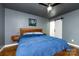 Cozy bedroom featuring hardwood floors, a stylish light fixture, and a sliding barn door at 8210 Lantana Dr, Denver, NC 28037
