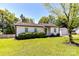 Charming single-story home featuring mature landscaping and a detached garage at 8210 Lantana Dr, Denver, NC 28037