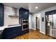 Kitchen featuring stainless steel appliances, custom blue cabinets and a pantry at 8210 Lantana Dr, Denver, NC 28037