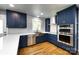 Updated kitchen with custom blue cabinets, stainless steel appliances, and subway tile backsplash at 8210 Lantana Dr, Denver, NC 28037