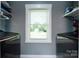 Well-lit laundry room featuring modern washer and dryer hookups, with views from a large window at 8210 Lantana Dr, Denver, NC 28037