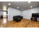 Spacious living room with hardwood flooring, recessed lighting, and a comfortable black leather sofa at 8210 Lantana Dr, Denver, NC 28037