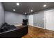Stylish living room featuring hardwood floors, recessed lighting, and a sleek sliding barn door at 8210 Lantana Dr, Denver, NC 28037