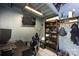 Interior view of an office space above a garage with a desk, shelves and gaming chair at 8210 Lantana Dr, Denver, NC 28037
