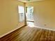 A well-lit bedroom featuring hardwood floors and one window at 8608 Warwick Crest Ln, Charlotte, NC 28215