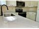 Close-up of kitchen featuring stainless steel appliances and quartz countertops at 8608 Warwick Crest Ln, Charlotte, NC 28215