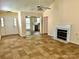 Open-concept living area with views of kitchen and fireplace, featuring tile floors at 8608 Warwick Crest Ln, Charlotte, NC 28215
