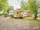 Spacious backyard featuring a charming gazebo with a red roof, surrounded by lush trees and greenery at 905 Mount Olivet Rd, Kannapolis, NC 28083