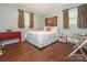 Comfortable bedroom with a queen-size bed, wooden floors, tapestry and a red accent dresser at 905 Mount Olivet Rd, Kannapolis, NC 28083