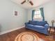 Spare bedroom showcasing a comfortable blue sofa, round jute rug, and wood floors at 905 Mount Olivet Rd, Kannapolis, NC 28083