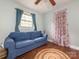 Cozy bedroom with a blue sofa, a jute rug, wood floors and natural lighting at 905 Mount Olivet Rd, Kannapolis, NC 28083