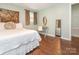 Bright bedroom with a tapestry, white bedding, wood floors, and natural light at 905 Mount Olivet Rd, Kannapolis, NC 28083