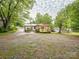 Exterior view shows the house from the side with a gazebo in the front yard at 905 Mount Olivet Rd, Kannapolis, NC 28083
