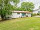Charming one-story home with brick facade, red roof, well-maintained lawn and beautiful plants at 905 Mount Olivet Rd, Kannapolis, NC 28083
