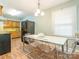Kitchen with light blue walls, modern appliances, wood cabinets, and a large dining table for Gathering gatherings at 905 Mount Olivet Rd, Kannapolis, NC 28083