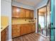 Galley kitchen with warm wood cabinets, yellow countertops, and a view to the sunroom at 905 Mount Olivet Rd, Kannapolis, NC 28083