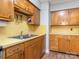 Kitchen featuring wood cabinets, stainless steel sink, and yellow countertops at 905 Mount Olivet Rd, Kannapolis, NC 28083
