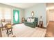 Inviting living room with a comfortable green leather couch, area rug, and blue accent wall at 905 Mount Olivet Rd, Kannapolis, NC 28083