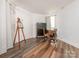 Bright room featuring wood floors, an easel with picture, and a writing desk by the window at 905 Mount Olivet Rd, Kannapolis, NC 28083