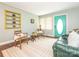 Inviting living room with a comfortable green leather couch, area rug, and blue accent wall at 905 Mount Olivet Rd, Kannapolis, NC 28083