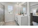 Bright bathroom features double sink vanities, a large mirror, and modern fixtures, creating a clean and functional space at 9424 Avery Lilac Ln # 83, Fort Mill, SC 29707