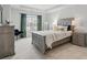 A well-lit bedroom featuring neutral walls, plush carpet, and a comfortable bed by a bright window at 9424 Avery Lilac Ln # 83, Fort Mill, SC 29707