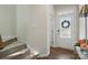 Bright entryway featuring a decorative front door, wood floors, and staircase to the upper level at 9424 Avery Lilac Ln # 83, Fort Mill, SC 29707