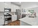 Modern kitchen featuring stainless steel appliances, white cabinets, and an island with bar seating at 9424 Avery Lilac Ln # 83, Fort Mill, SC 29707