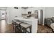 Open-concept kitchen with white cabinets, stainless steel appliances, and a quartz-topped island with seating at 9424 Avery Lilac Ln # 83, Fort Mill, SC 29707