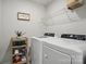Functional laundry room featuring modern washer and dryer, wire shelving, and neutral decor, maximizing space and efficiency at 9424 Avery Lilac Ln # 83, Fort Mill, SC 29707