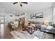 Inviting living room featuring hardwood floors, a comfortable sofa, and a view of the modern kitchen at 9424 Avery Lilac Ln # 83, Fort Mill, SC 29707