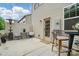 A cozy patio area with an outdoor table, chairs, and landscaping, perfect for relaxing outdoors at 9424 Avery Lilac Ln # 83, Fort Mill, SC 29707
