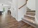 Staircase with wood floors and carpeted steps, connecting the living spaces to the upper level at 9424 Avery Lilac Ln # 83, Fort Mill, SC 29707