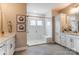 This bright bathroom features a glass enclosed shower, double vanity, and white cabinets at Tbd Boomer Ct # 7, Statesville, NC 28677