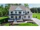 Charming two-story home with white siding, black windows, covered porch and professionally landscaped front yard at Tbd Boomer Ct # 7, Statesville, NC 28677