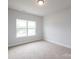 A bright bedroom with neutral carpet and natural light from a large window at 1030 Gardenia Dr # 2, Mt Ulla, NC 28125