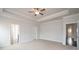 Spacious carpeted bedroom with trey ceilings, ceiling fan, and ample natural light from two windows at 1030 Gardenia Dr # 2, Mt Ulla, NC 28125