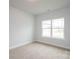 Bedroom with neutral carpet, base molding, and a large window for natural light at 1030 Gardenia Dr # 2, Mt Ulla, NC 28125