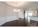Dining room with hardwood floors, elegant chandelier, and white trim at 1030 Gardenia Dr # 2, Mt Ulla, NC 28125