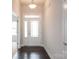 Entryway featuring a light-filled foyer with dark wood floors and a glass-paneled front door at 1030 Gardenia Dr # 2, Mt Ulla, NC 28125